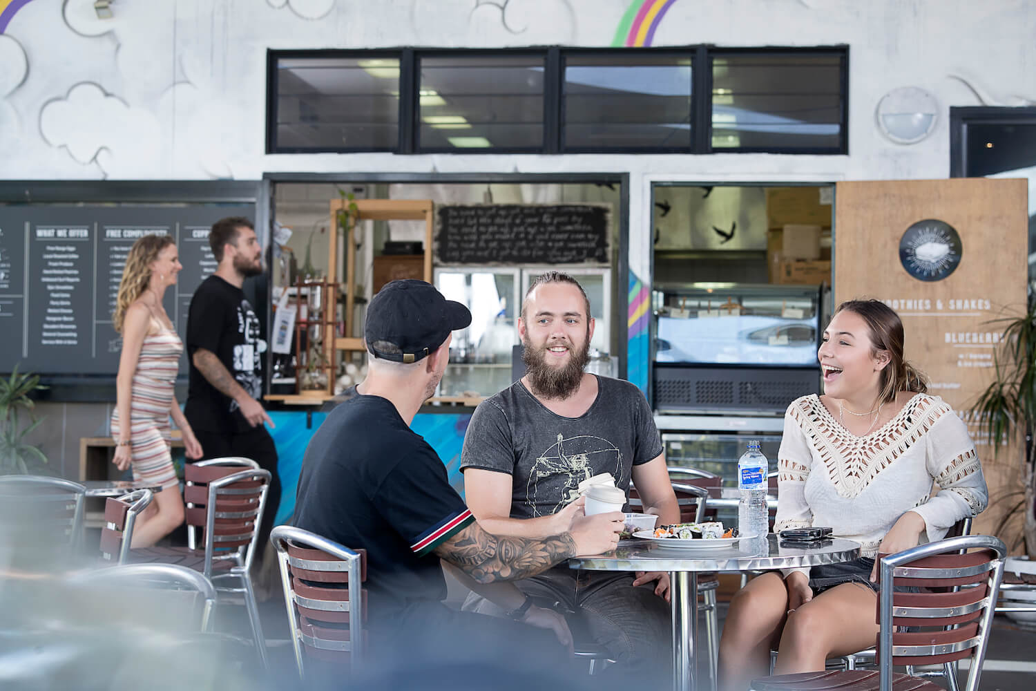 Three people sitting in the cafeteria