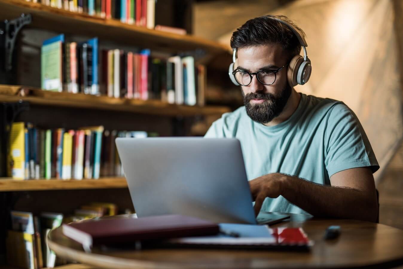 A man sitting at a table in a library.