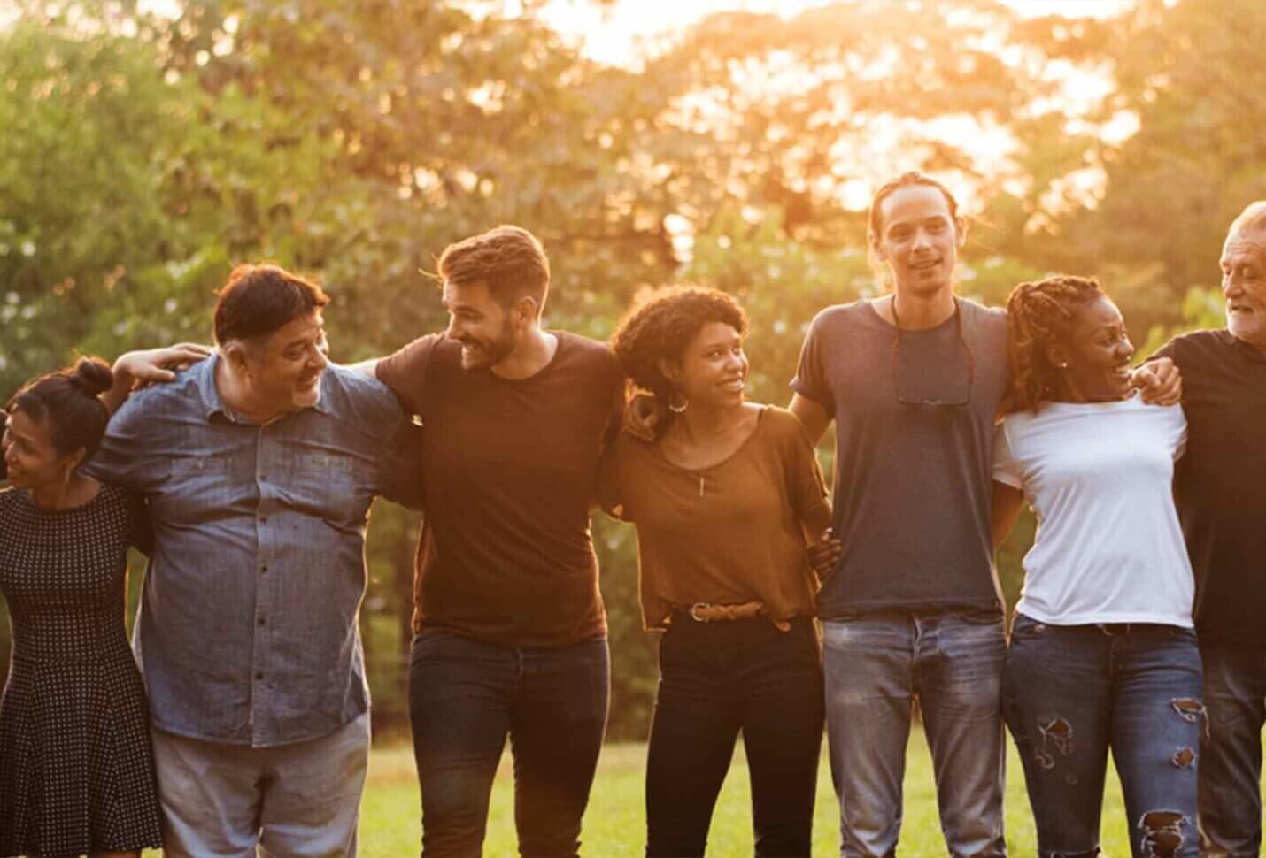 Group of people lines up in a park People together. varied ages. ethnicity