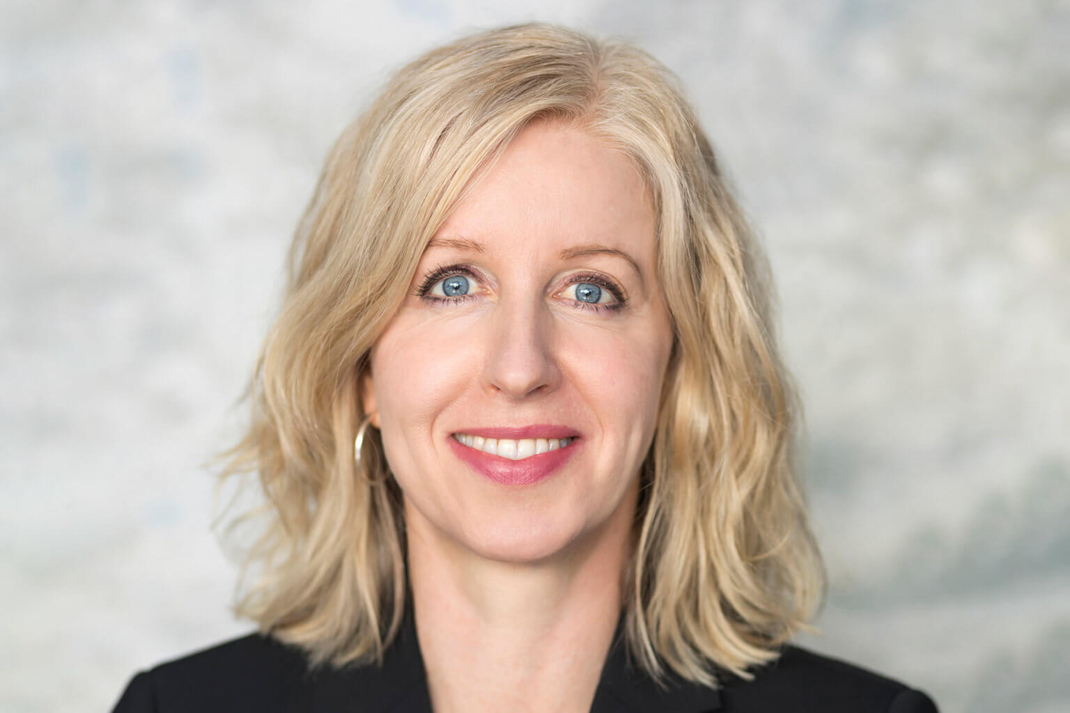 A corporate headshot profile picture of a woman.