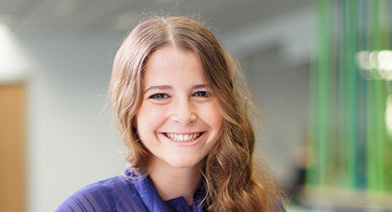 Young woman in purple shirt smiling