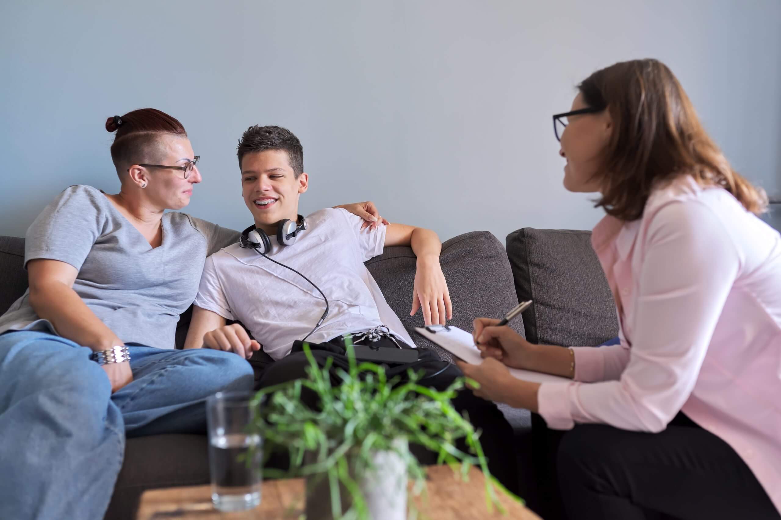 Mother with her teenage son at meeting with social worker, psychologist Psych Clinic family therapy scaled