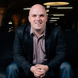 A man sitting and facing forward.