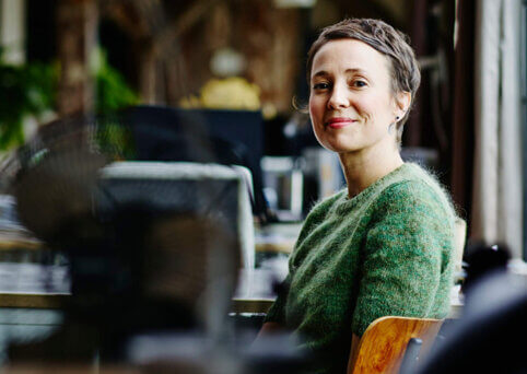 Image of a woman sitting at an empty office.