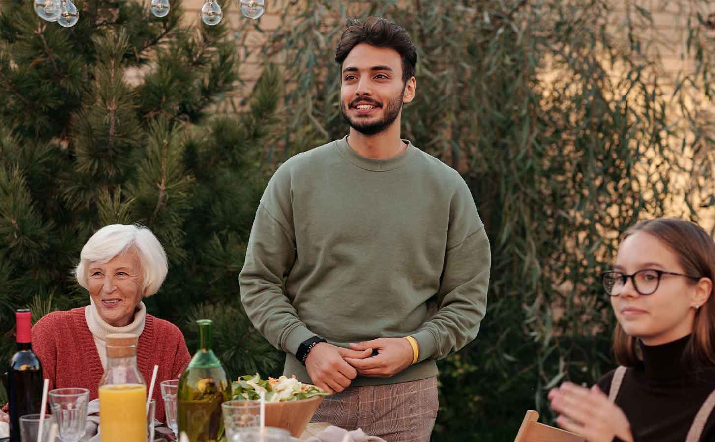 pexels-askar-abayev-5638619 A family around a table of food outside.