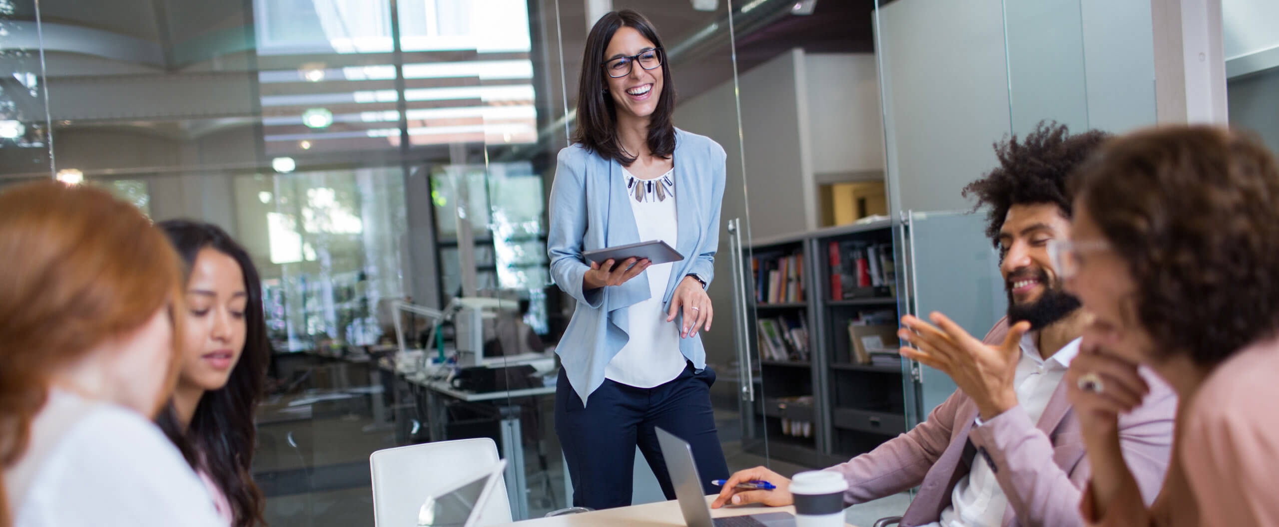 The human side of leadership (banner) Image of a woman presenting to her peers