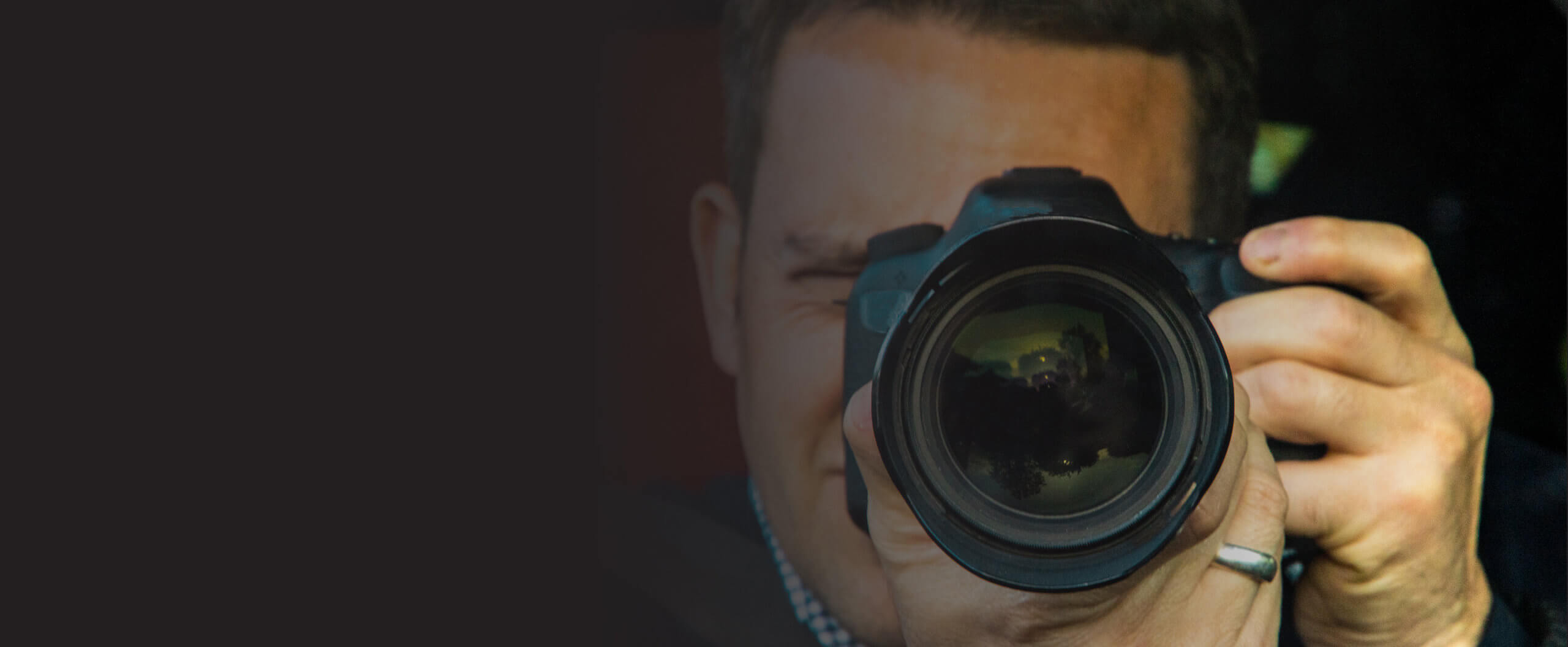 ACAP-191020211224-ExperienceACAP-LandingPageBanners-Criminology A photographer with a camera pointed forward.