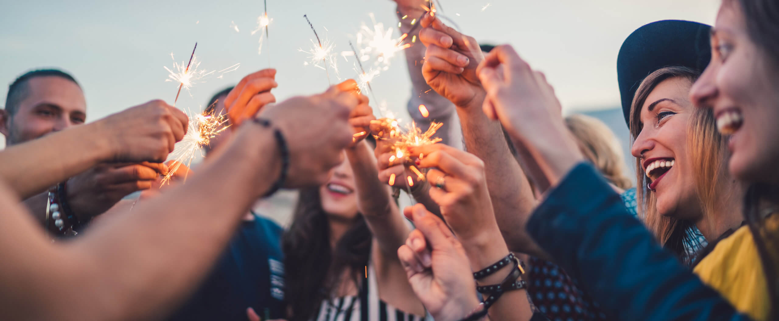 How to make your resolutions stick (banner) Image of people celebrating with sparklers