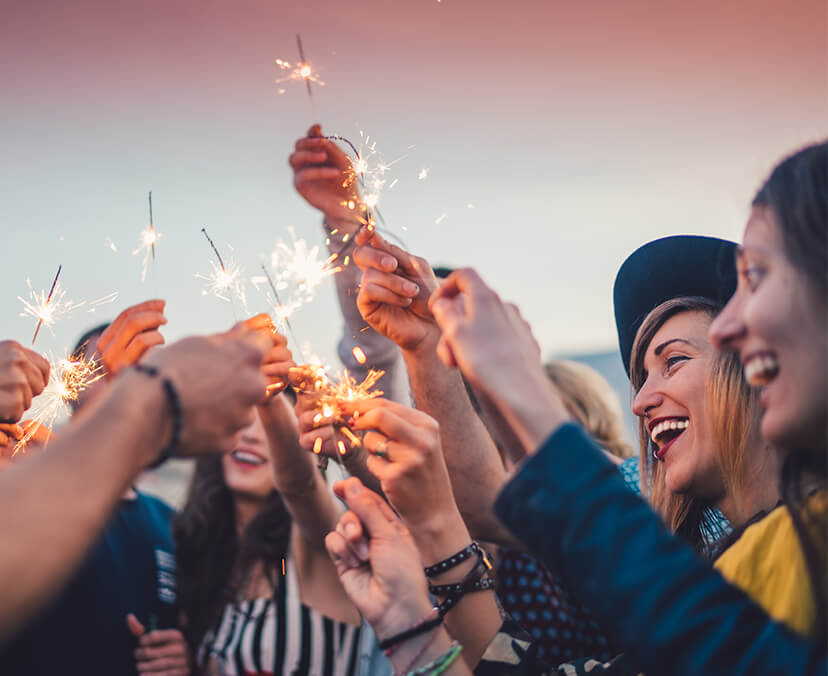 How to make your resolutions stick (banner) Image of people celebrating with sparklers