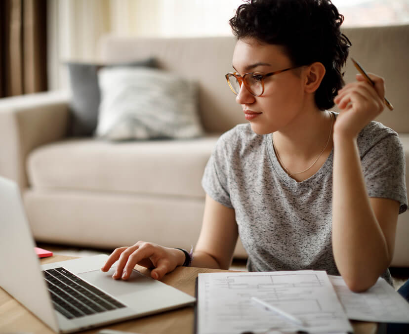 girl with pen in hand on a computer