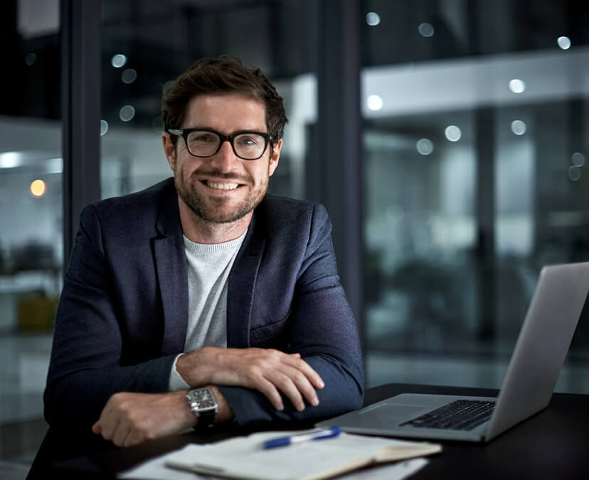 A smiling man sitting at a table.
