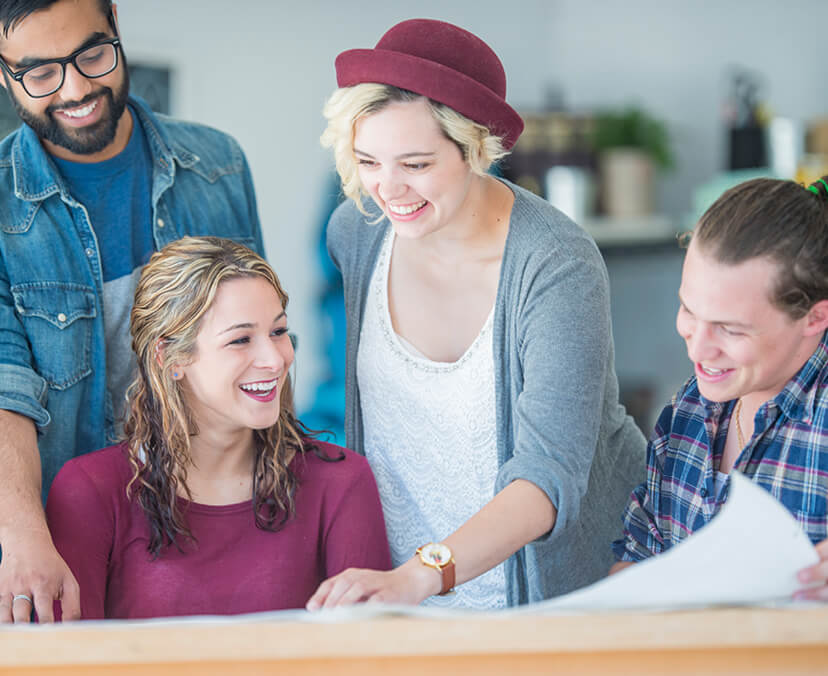 Group of four people working together.