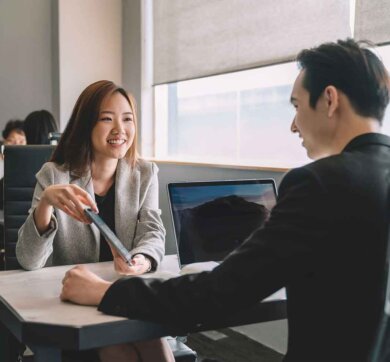 asian chinese manager and coworker having discussion in office Man and woman having a meeting