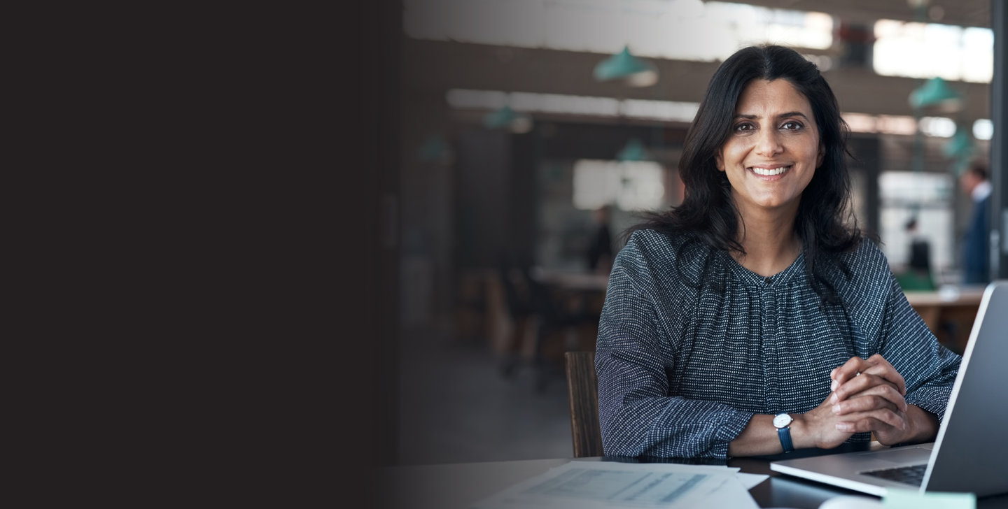 ACAP-202202281311-DiscoverACAP-April2022Sessions-DesktopBanners-MBA-AWWeb Woman sitting at a desk with laptop open.
