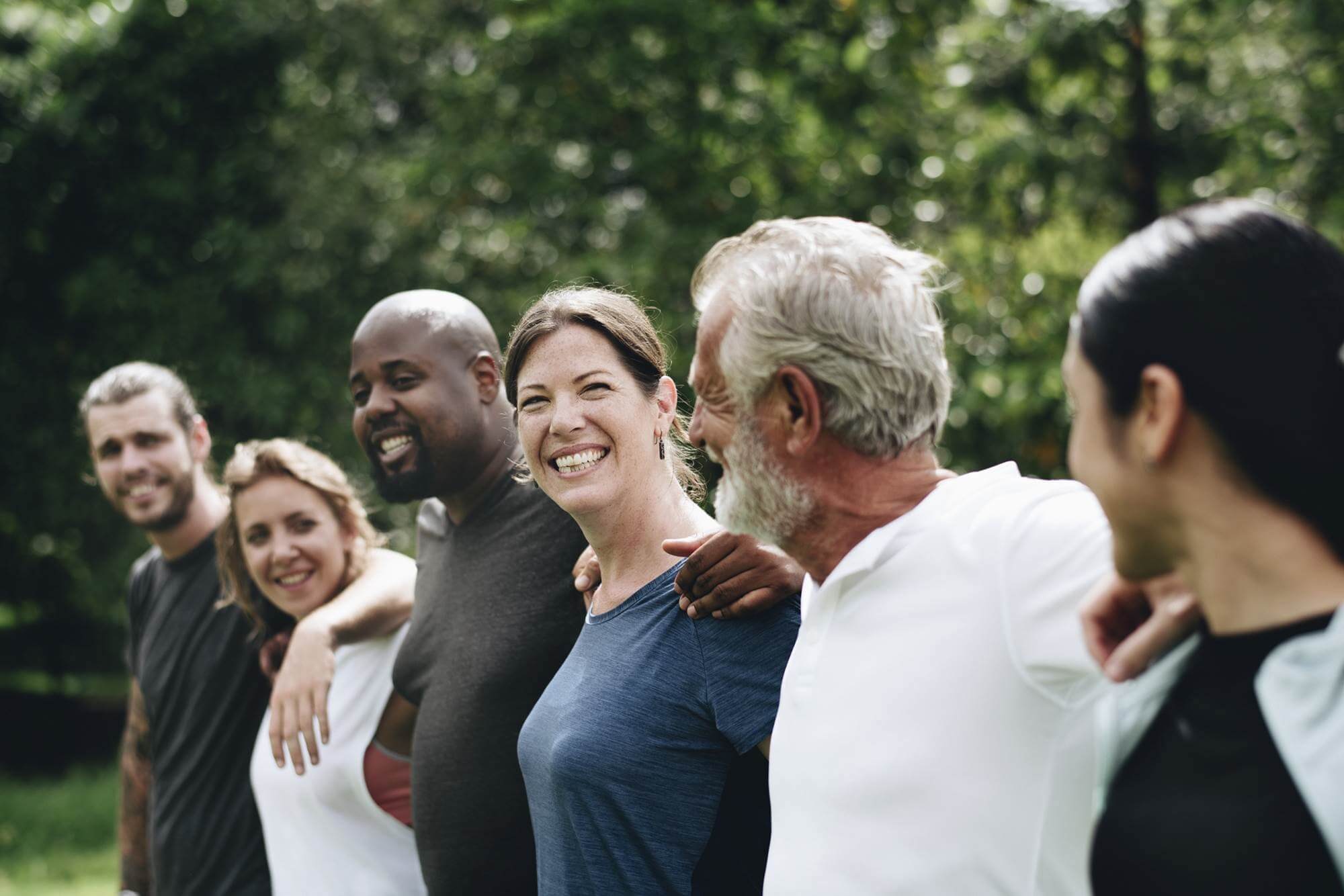 Group of people with arms around each other