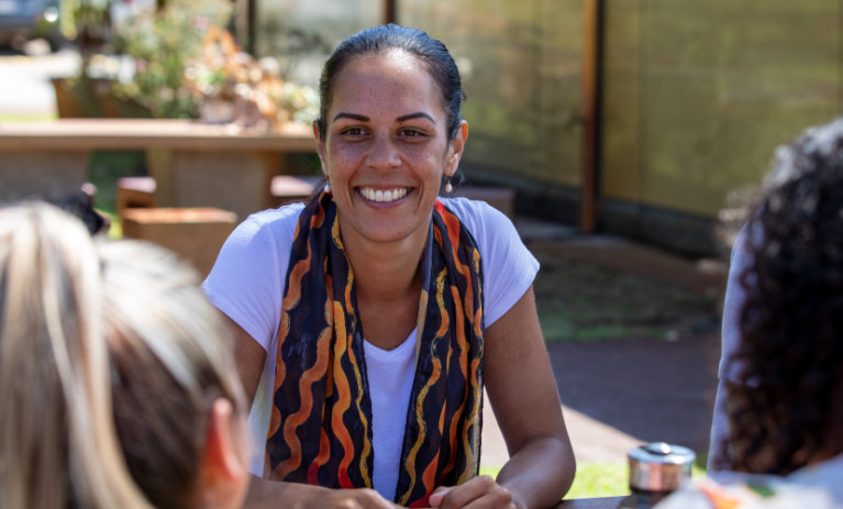 ACAP_BBOD_image_828x676 Woman smiling at two other people at the table.