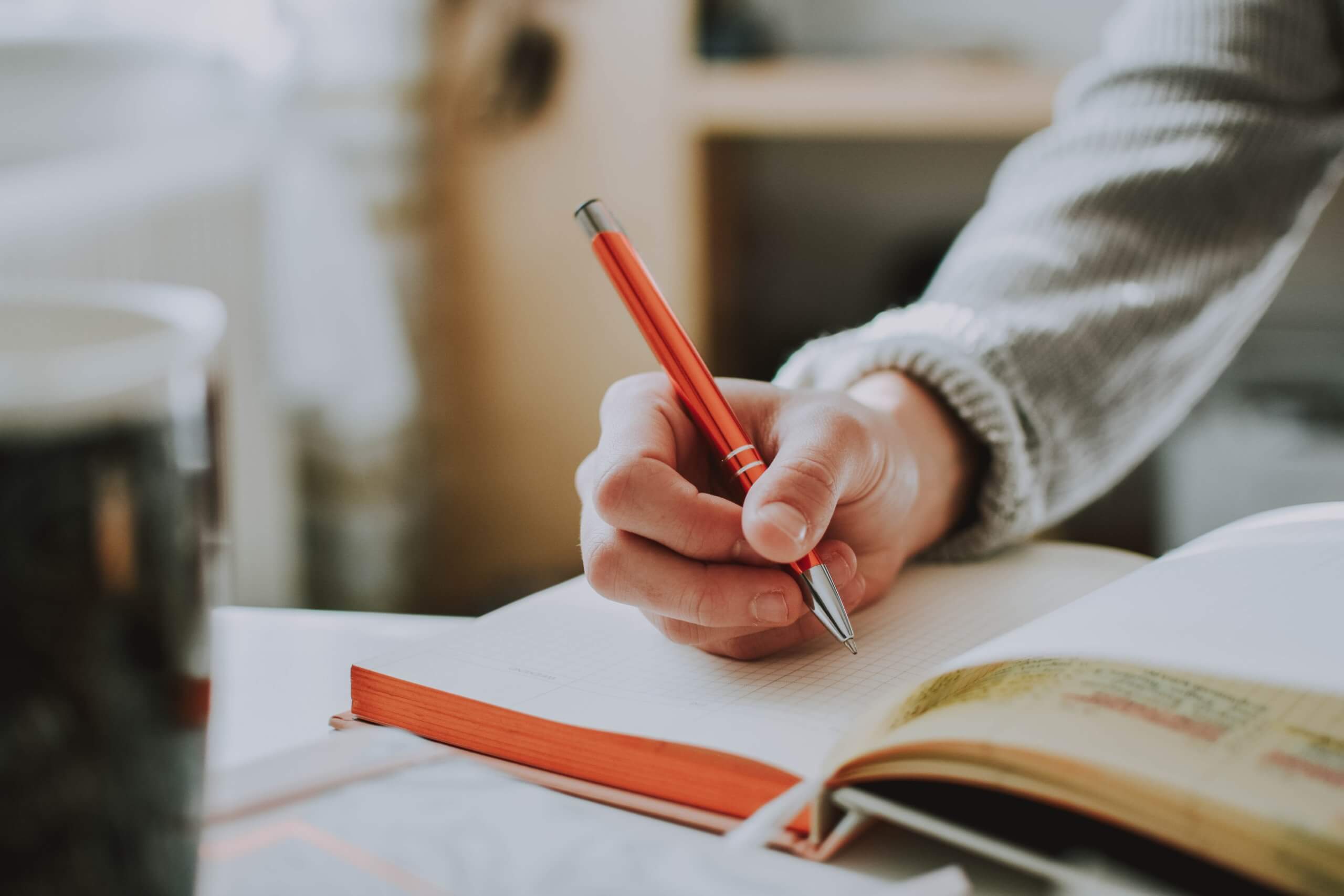 Close up of a student writing in a book.