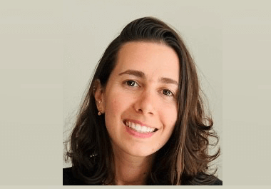 Woman with hair out smiling to camera