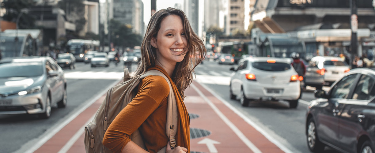 Girl with backpack on the road