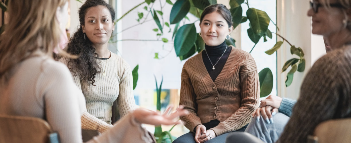 Woman sharing her experiences during a group therapy session