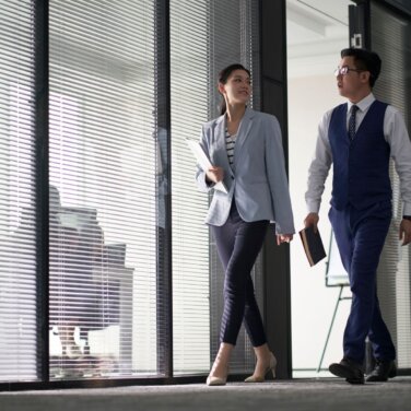 2 Colleagues walking in corridor