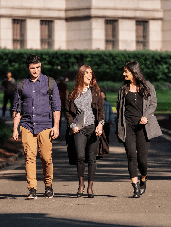 Three students walking together on college campus