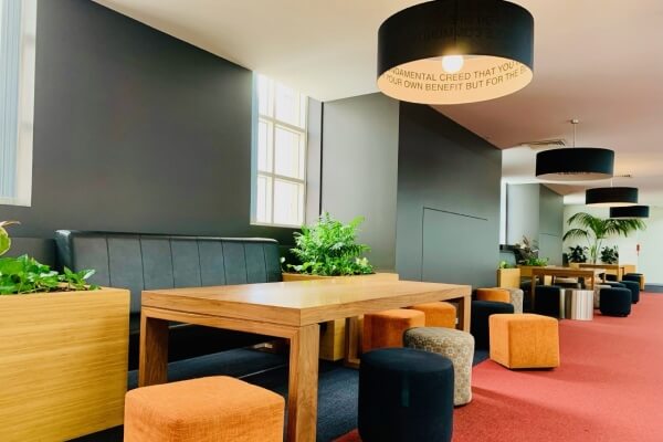 Work area with tables and chairs at ACAP Melbourne Campus