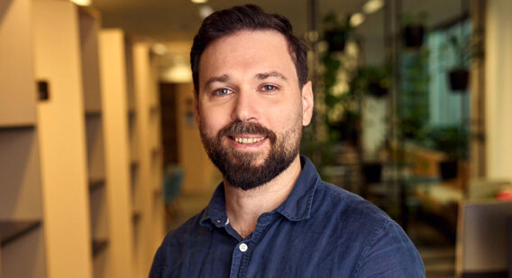 Male counselling student Alex standing at ACAP Sydney campus - close up profile shot