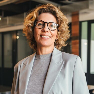 Female management student in business attire with glasses - close up profile shot