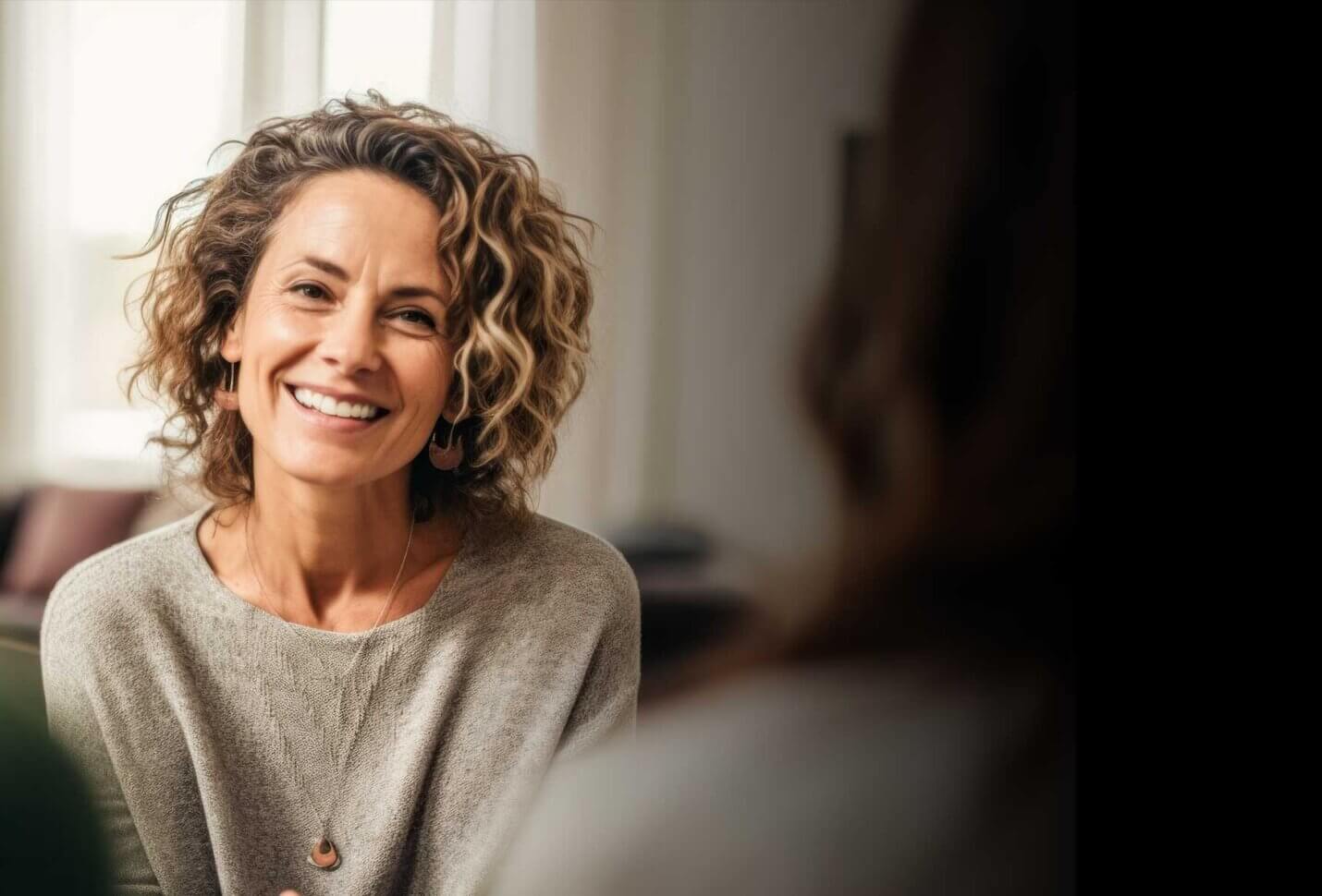 Smiling woman sitting in a therapy session