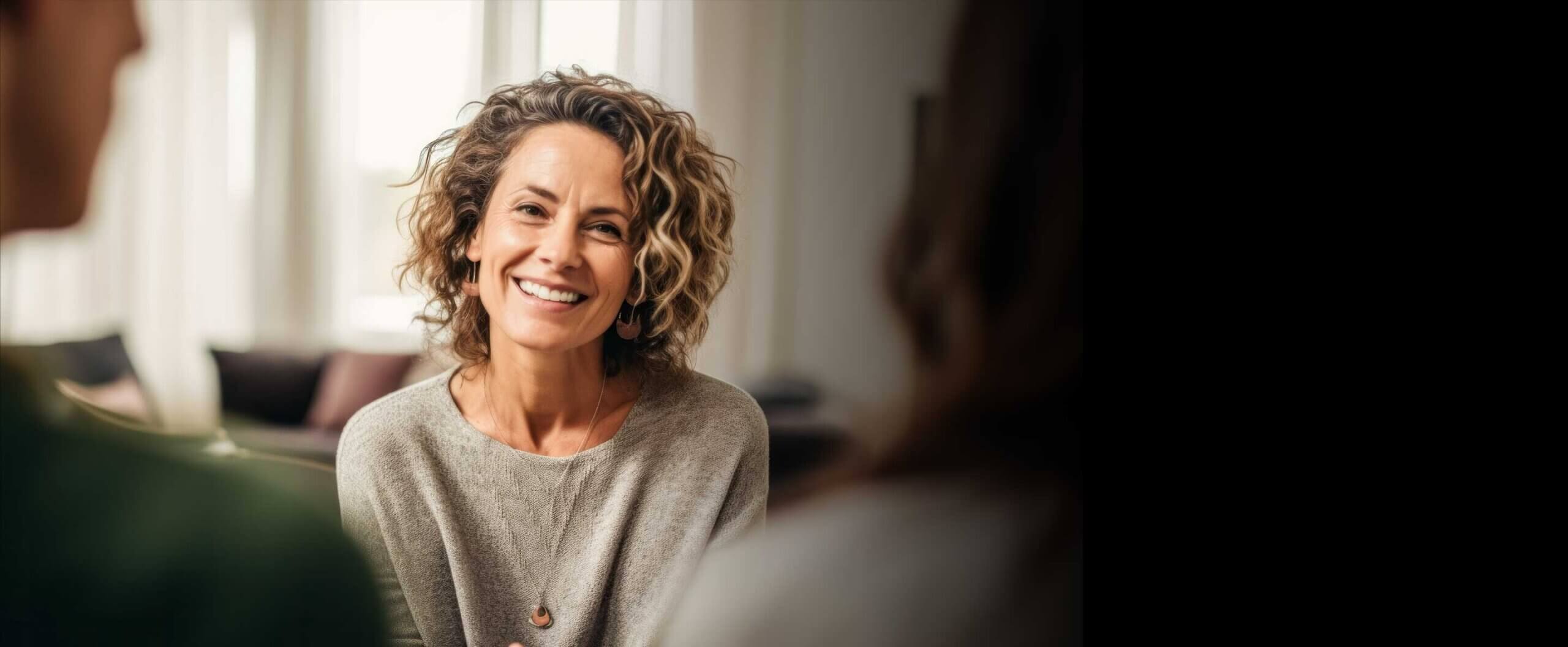 Smiling woman sitting in a therapy session