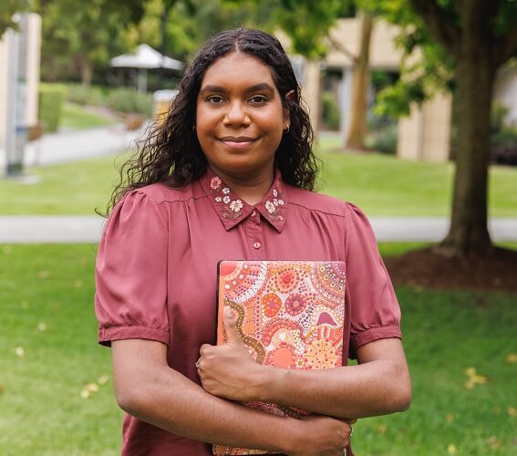Female Aboriginal Australian Student Holding Laptop
