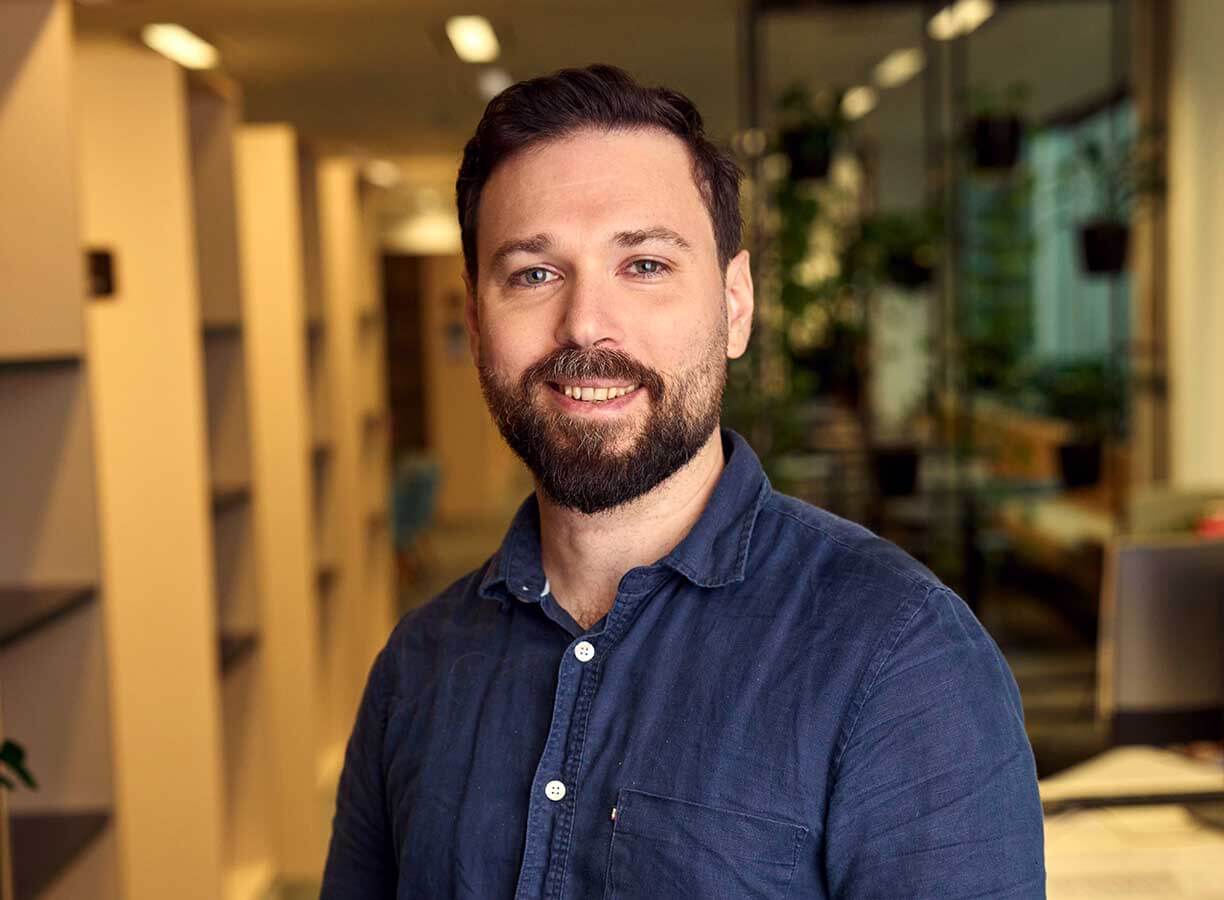 Male counselling student Alex standing at ACAP Sydney campus - close up profile shot