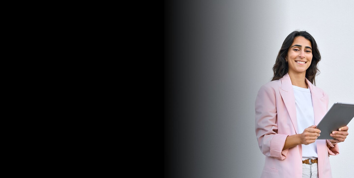 ACAP conference 2024 Woman stands in a pink jacket. With device.