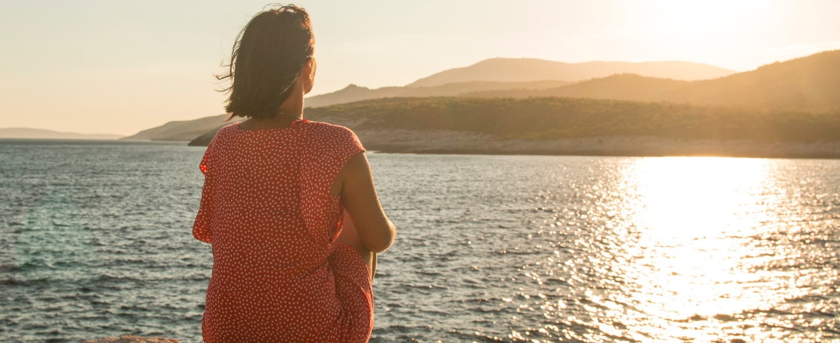 woman staring out over the ocean | [reflective learning]