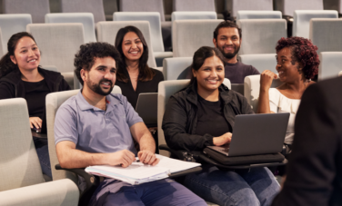 Students AI group of students in lecture theatre smiling