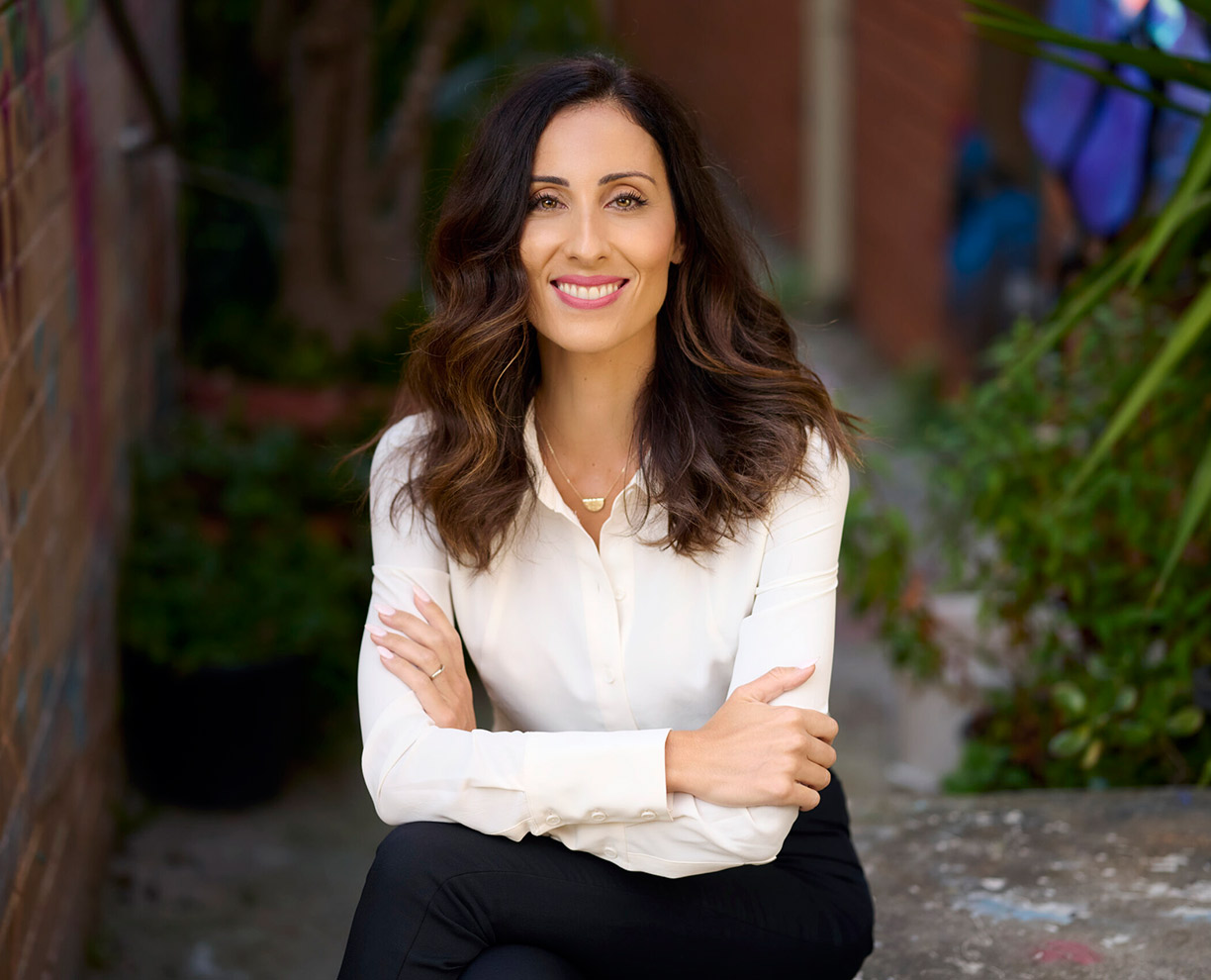 Desi-Vlahos-1224x990 Photo of GDLP course leader Desi Vlahos sitting with her legs and arms crossed